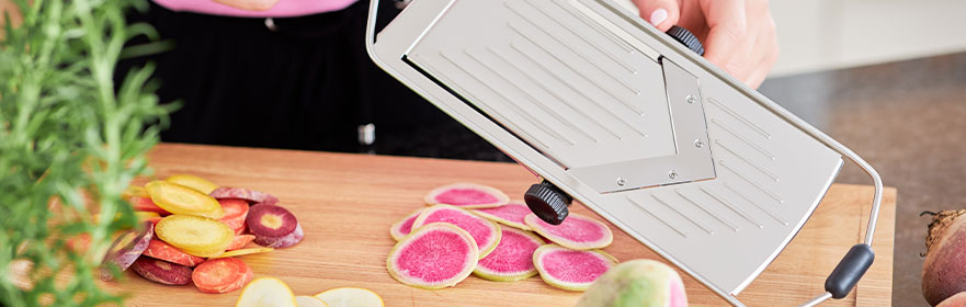 Slicing carrots on the slicer with V-blade